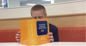 Emerson reading a textbook (Source: BizJournals.com).