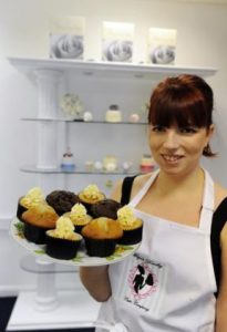 Megan with a plate of fresh baked cupcakes. Photo Courtesy: Echo News.