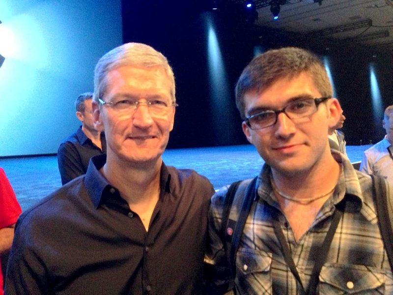 Apple CEO, Tim Cook standing with John Meyer